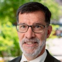 Portrait of a man with glasses and a beard, likely a researcher or award recipient.